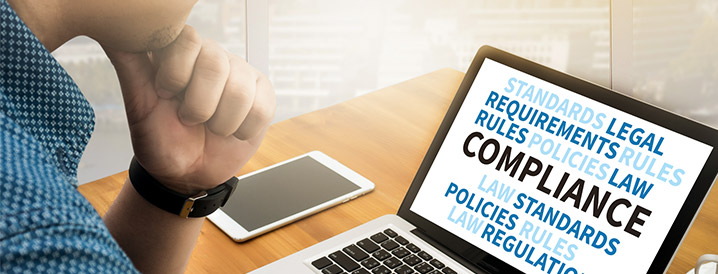 Man looking at computer screen that shows compliance risks in manufacturing, policies, rules, laws, and more