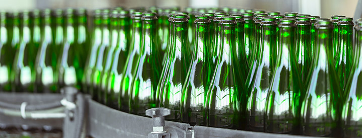 A line of green high-quality bottles on a manufacturing line