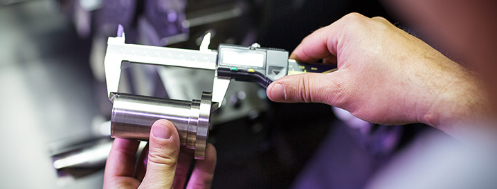 Up close metal component being examined for product quality