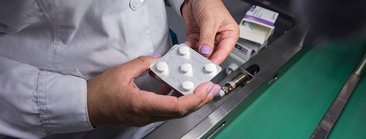A lady's hands holding pill packaging