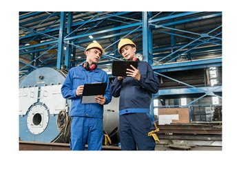 Two manufacturing engineers review an SPC analysis of their quality data.